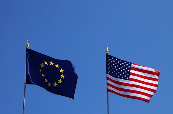 USA and EU flags next to each other waving in the wind 