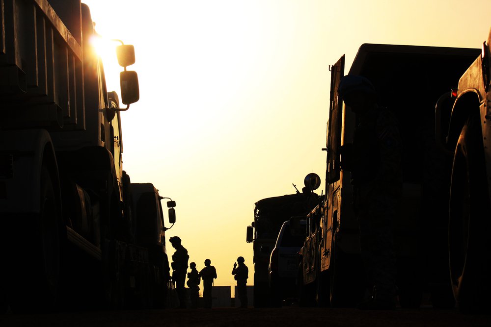 Silhouette of soldiers with vehicle